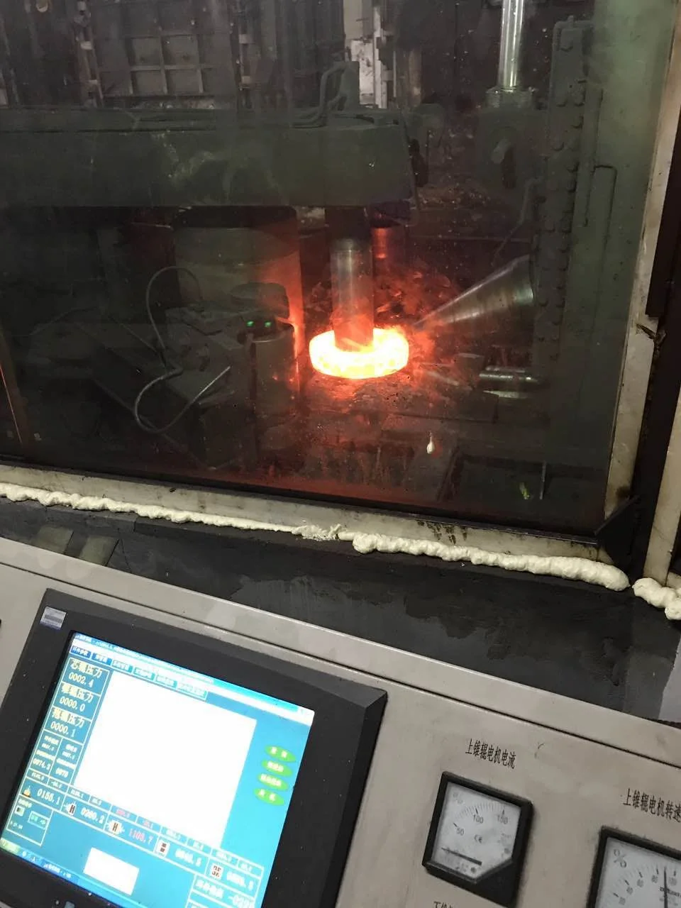 Nimonic 80A ring being roll-forged at forging temperature on the ring-rolling mill at Jiangsu Liangyi
